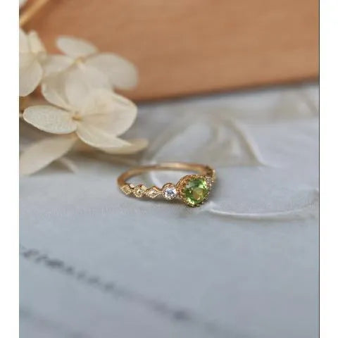 Quadrilateral geometric copper ring with imitation peridot stone, showing angular design and metallic finish