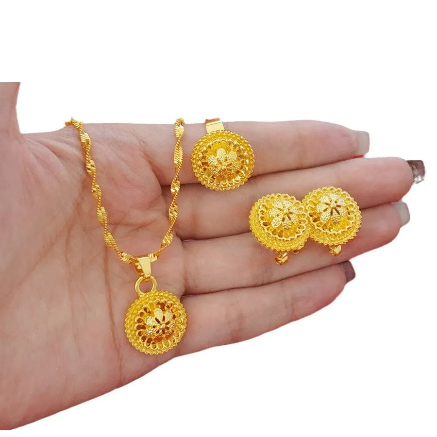 Gold-plated three-piece jewellery set with floral design, showing necklace, earrings, and ring with electroplated finish