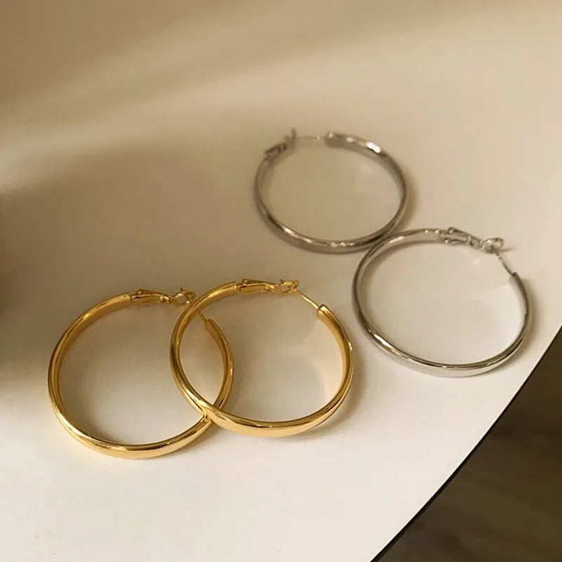 Pair of 40mm diameter circle earrings with electroplated gold or silver finish on copper