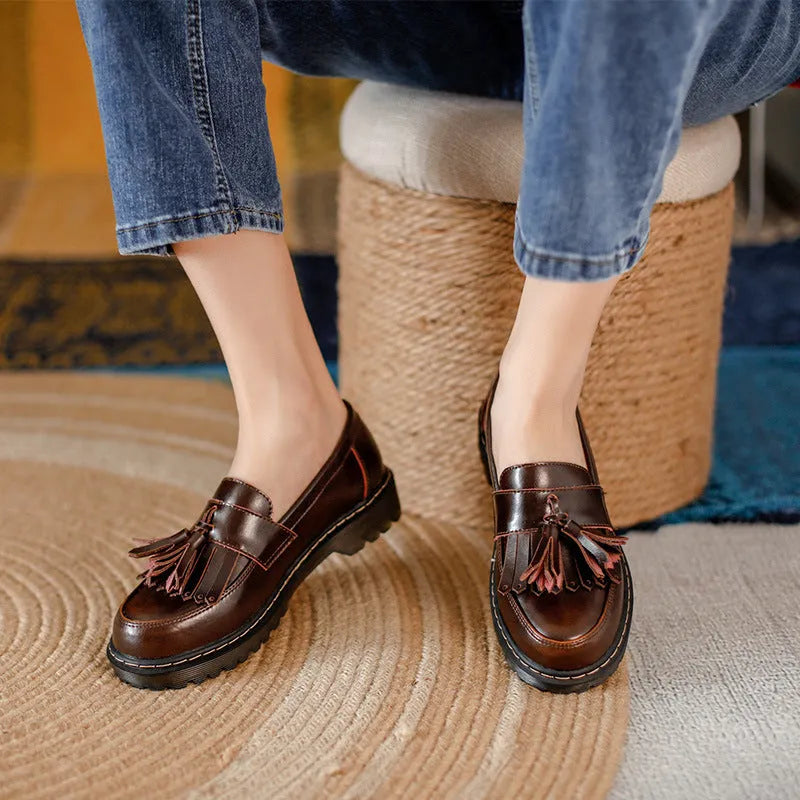 Women's brown leather tassel loafers with a chunky low heel and round toe