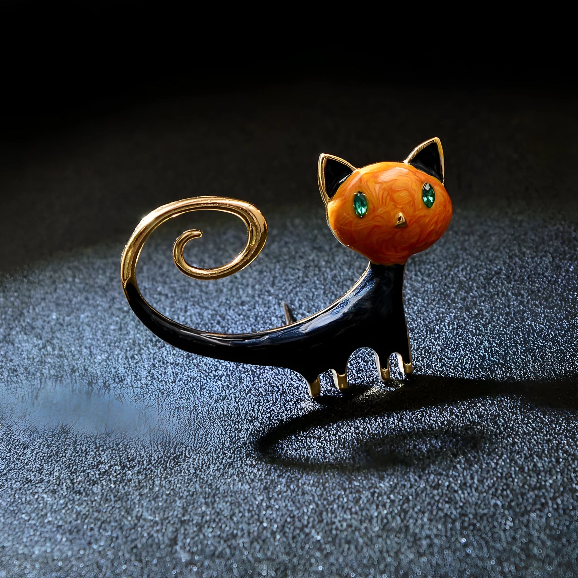 Close-up of a white alloy brooch with a painted tail-up kitten design.