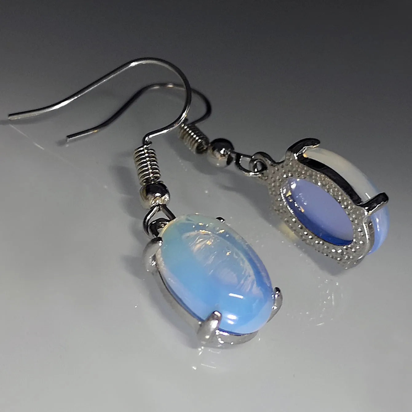 Electroplated alloy opal earrings with moonlight white finish and retro moonstone drop design featuring cross motif
