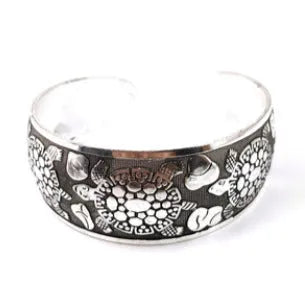Ethnic style Miao silver bracelet with open carved design in Roman shape, showing diamond treatment surface detail