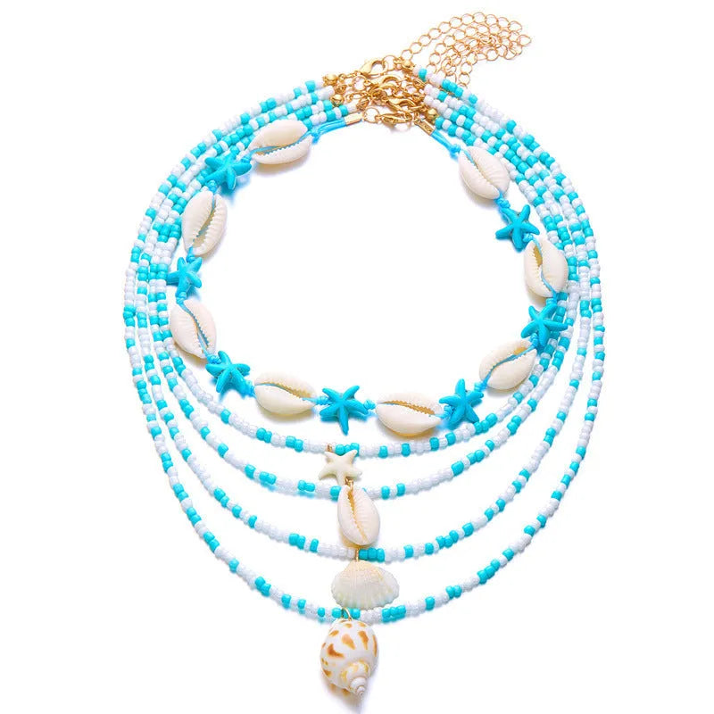 Blue and multi-colour women's multi-layer necklace set with shell, conch, and starfish bead pendants on a white background.