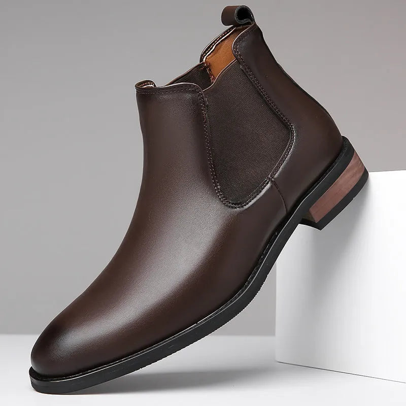 Men's black pointed toe Chelsea boots with a high-top design and decorative stitching on a rubber sole.