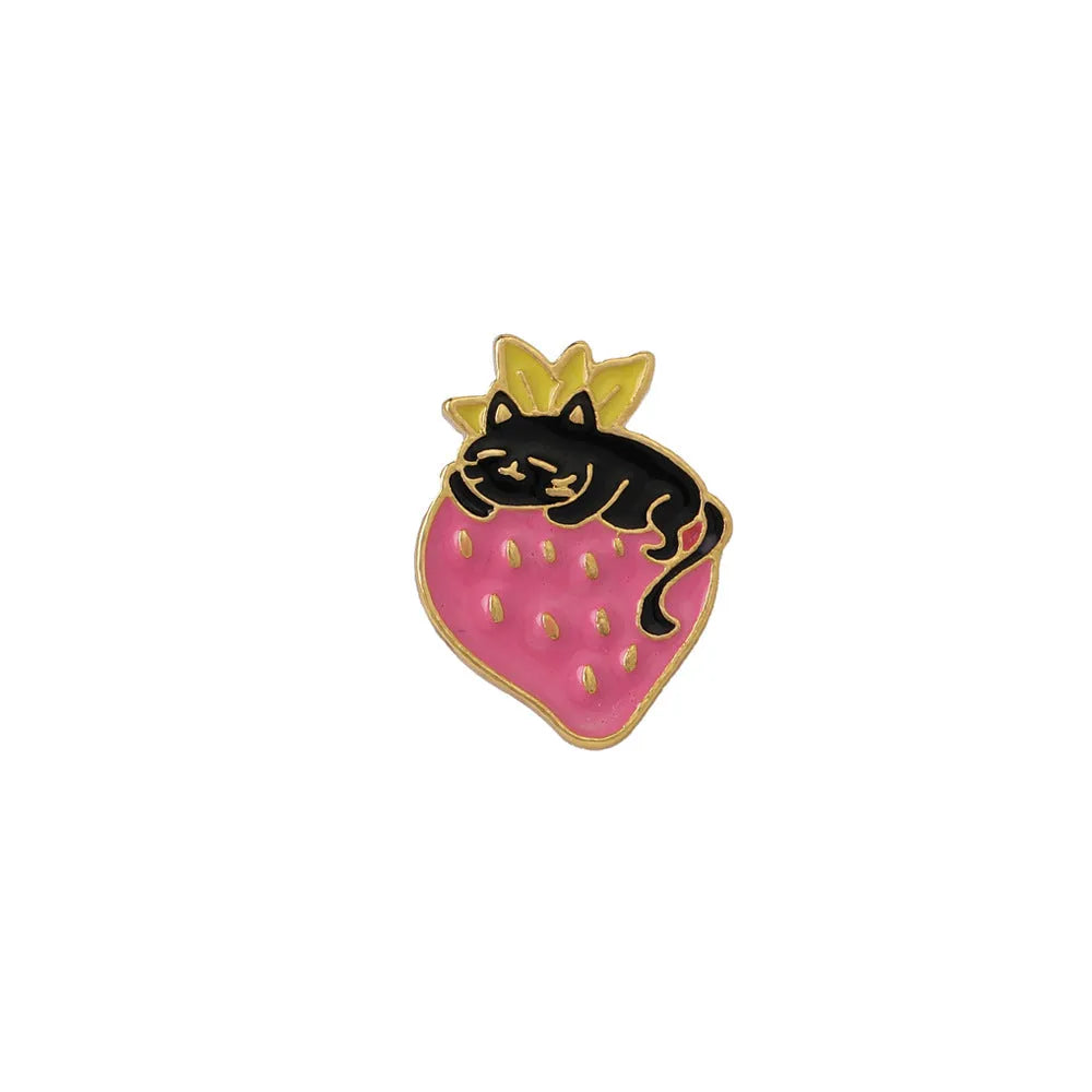 Alloy brooch with a cute cat, strawberry, and dripping oil design in metallic colours.