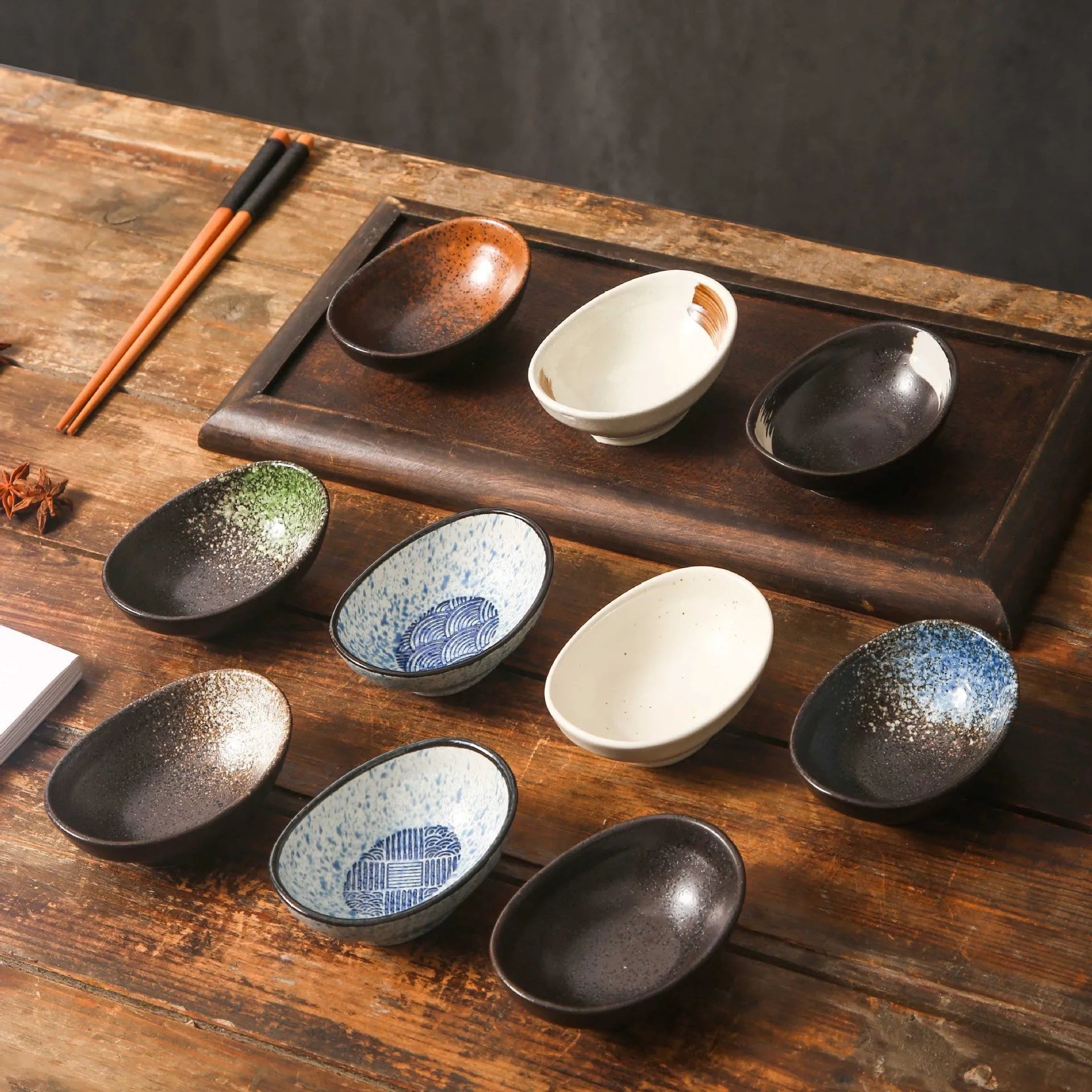 Oval Japanese ceramic sauce dipping bowl with underglaze pattern, measuring 9cm x 6cm x 4cm