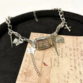 Dark multi-layer women's necklace with cross pendant and large hemp flower chain, adjustable length.