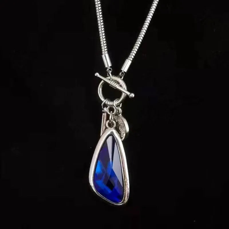 Long geometric alloy pendant necklace with snake bones chain for layering over jumpers
