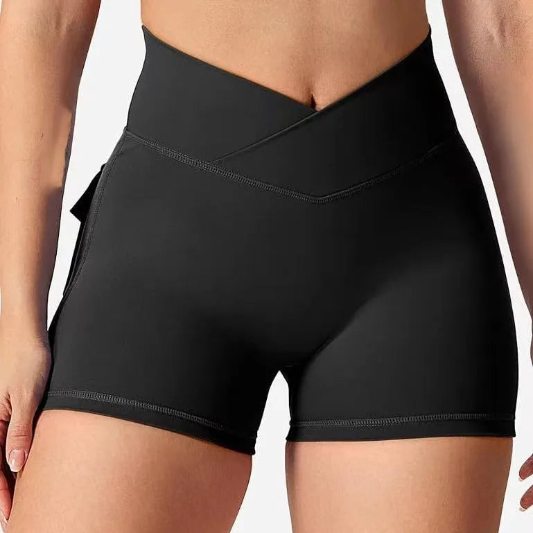Women's hip tight fitting nylon-blend workout shorts in grey, shown on a model.