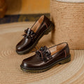 Women's black leather shoes with round toe and chunky flat heel in British style.