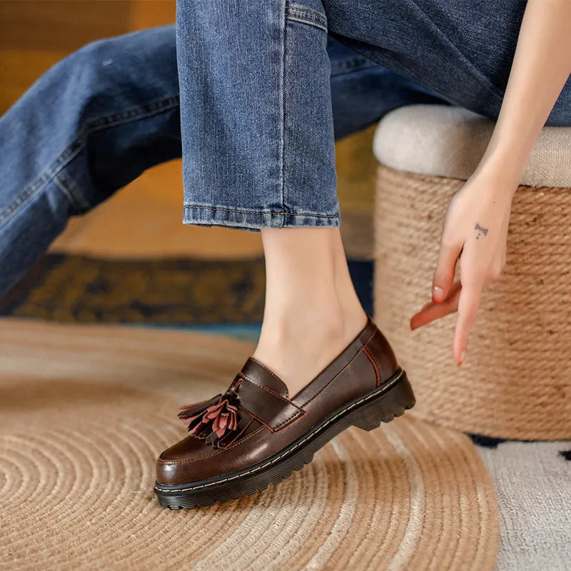 Women's brown leather tassel loafers with a chunky low heel and round toe