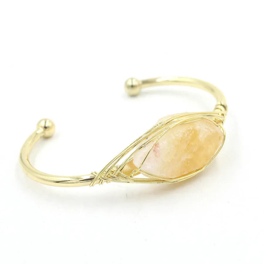 Natural raw gemstone bracelet with 8mm amorphous crystals in various colours on a wrist, showing ethnic style and simple clasp.