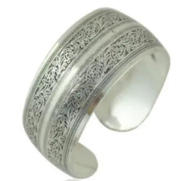 Ethnic style Miao silver bracelet with open carved design in Roman shape, showing diamond treatment surface detail