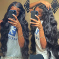 Black synthetic front lace wig with long curly hair and side bangs, showing natural hairline and 180% density