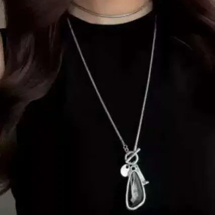 Long geometric alloy pendant necklace with snake bones chain for layering over jumpers