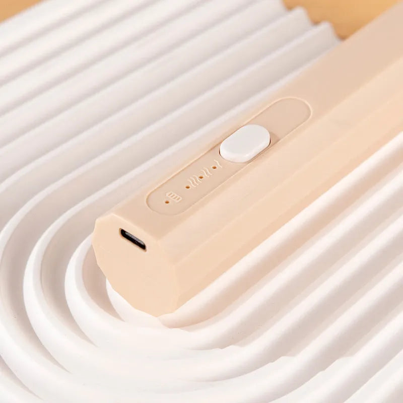 USB rechargeable handheld electric whisk in apricot colour with whisk attachment