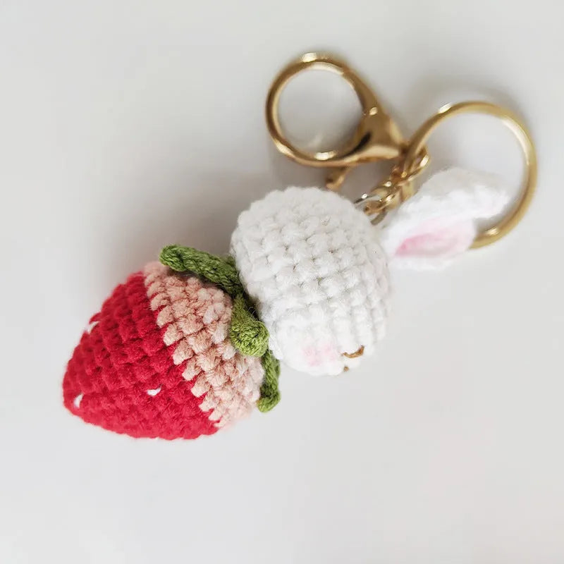 White hand-woven rabbit strawberry pendant with cartoon design and attached key on four-strand doll wire