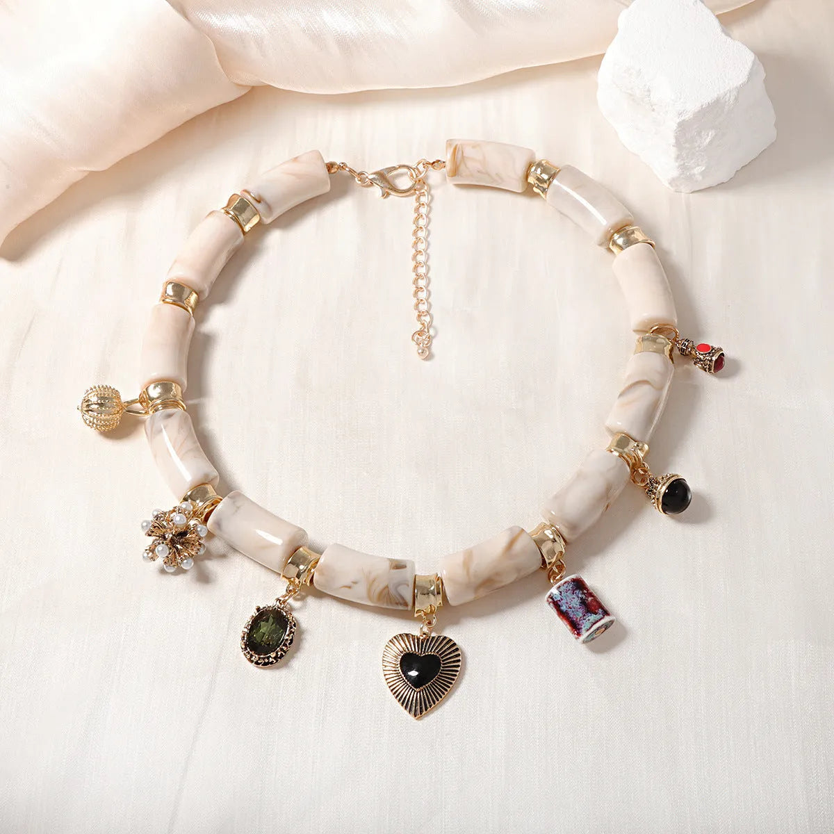 Heart-shaped plastic/resin pendant necklace with electroplated finish in picture colour