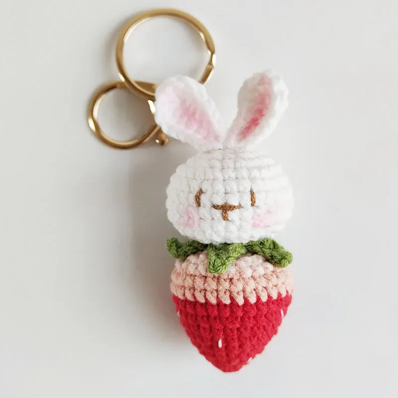 White hand-woven rabbit strawberry pendant with cartoon design and attached key on four-strand doll wire