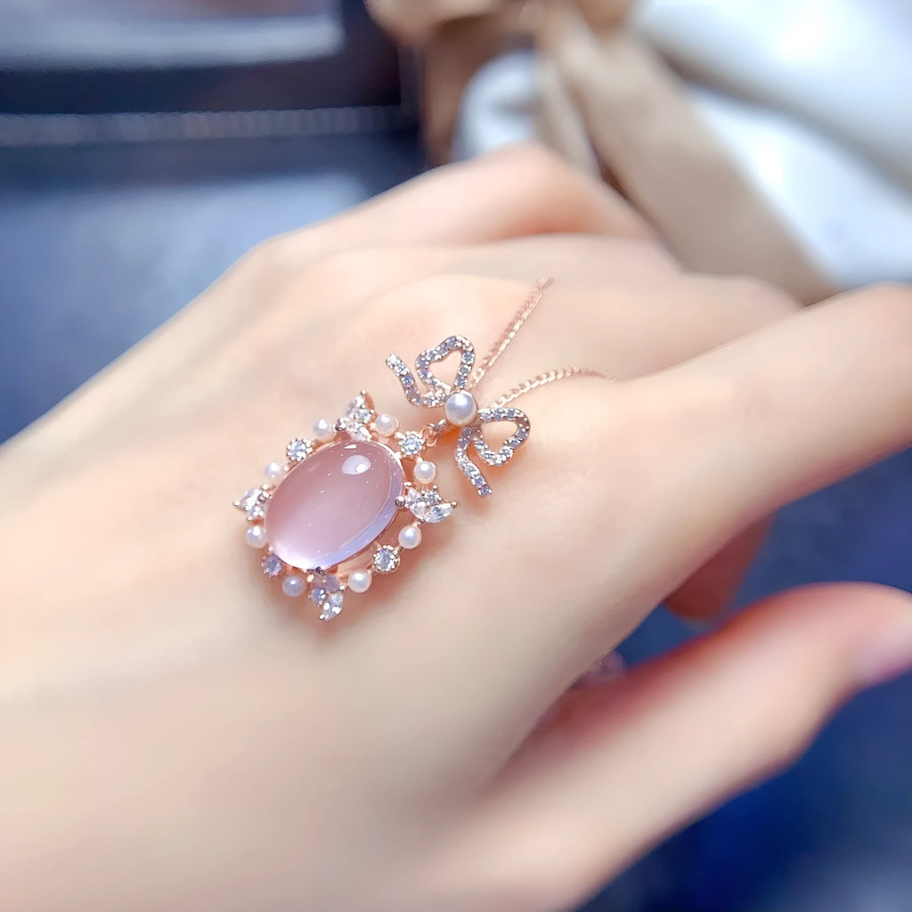 Geometric silver pendant with pink rose quartz crystal and rose gold plating on necklace chain