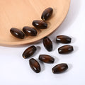 Oval wooden beads in dark coffee colour with M-shaped raised profile