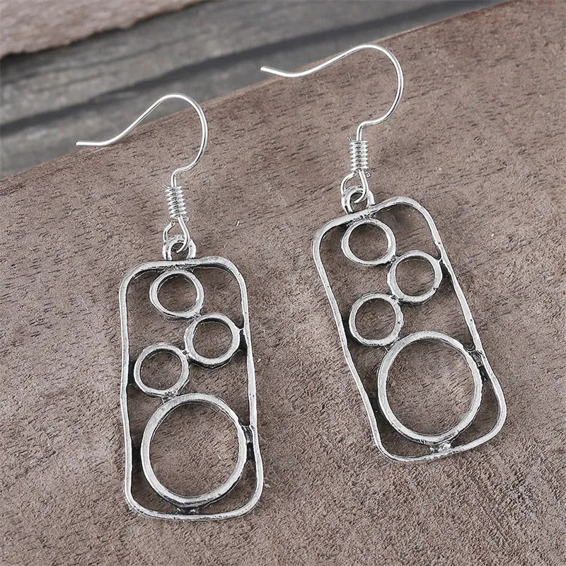 Pair of antique silver geometric earrings with an irregular square stud and round ring on zinc alloy posts.