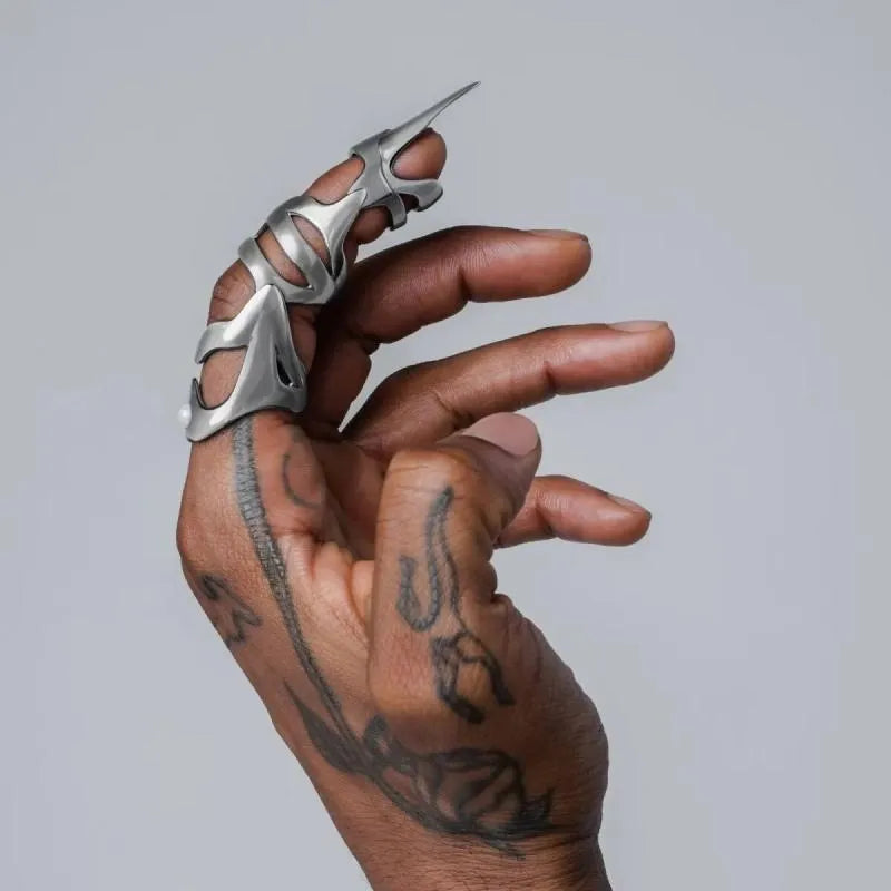 Silver alloy punk armour finger stall with textured ridges on a hand