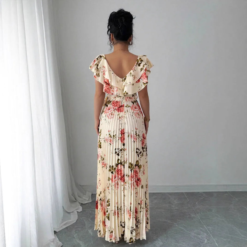 V-neck floral print dress with oversized swing skirt and ruffled sleeves in apricot colour, showing high waist and pleated details