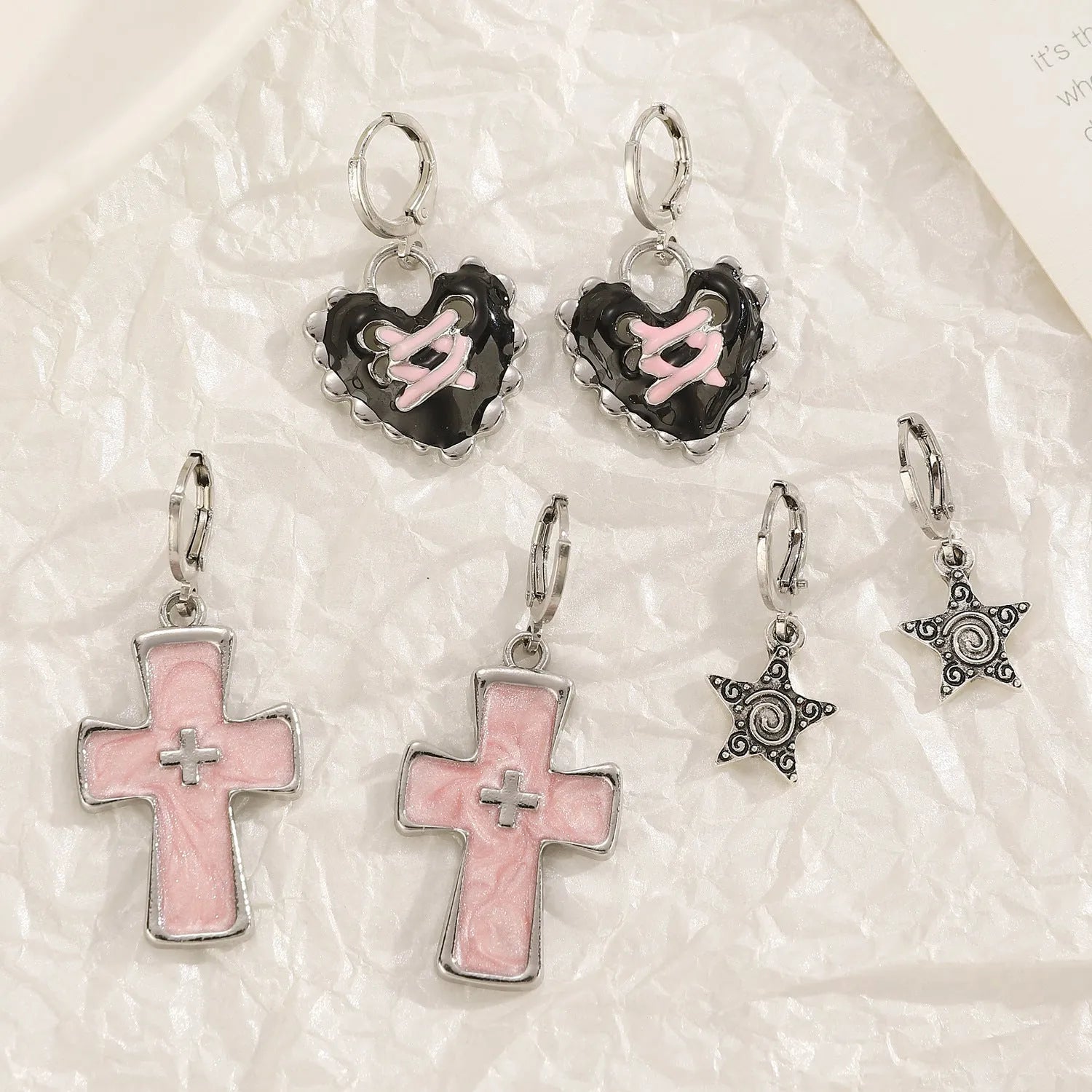 Women's alloy earrings with dripping oil treatment in five colour options showing cross and heart designs