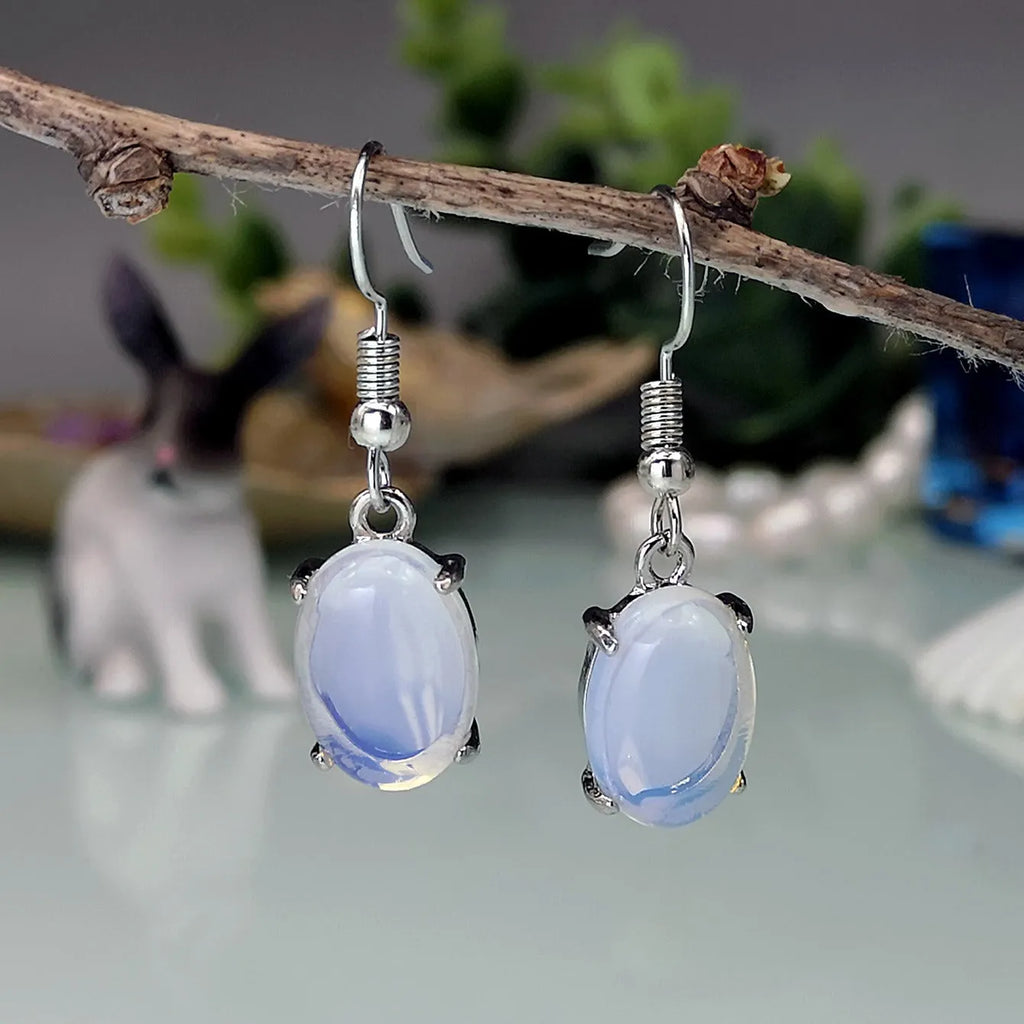 Electroplated alloy opal earrings with moonlight white finish and retro moonstone drop design featuring cross motif