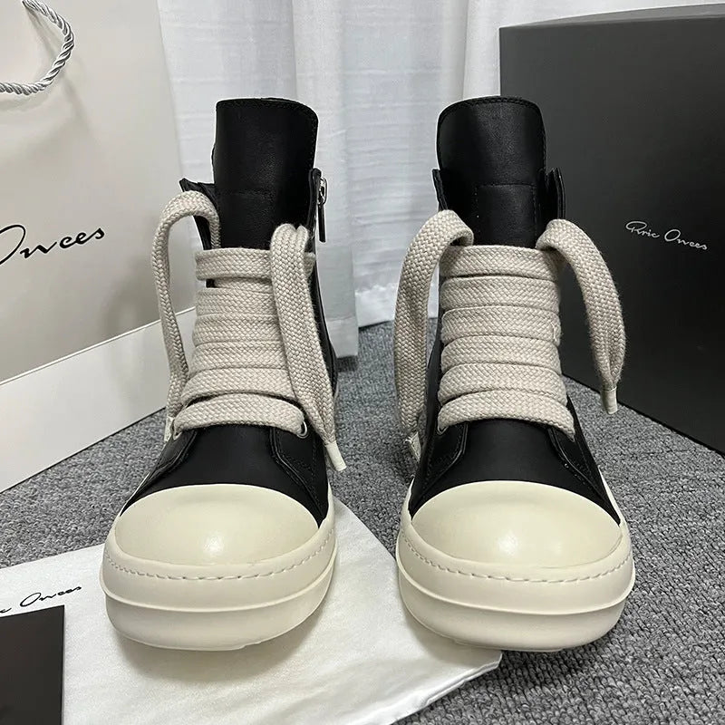 High-top leather sneakers with side zipper in black, showing platform heel and stitching details