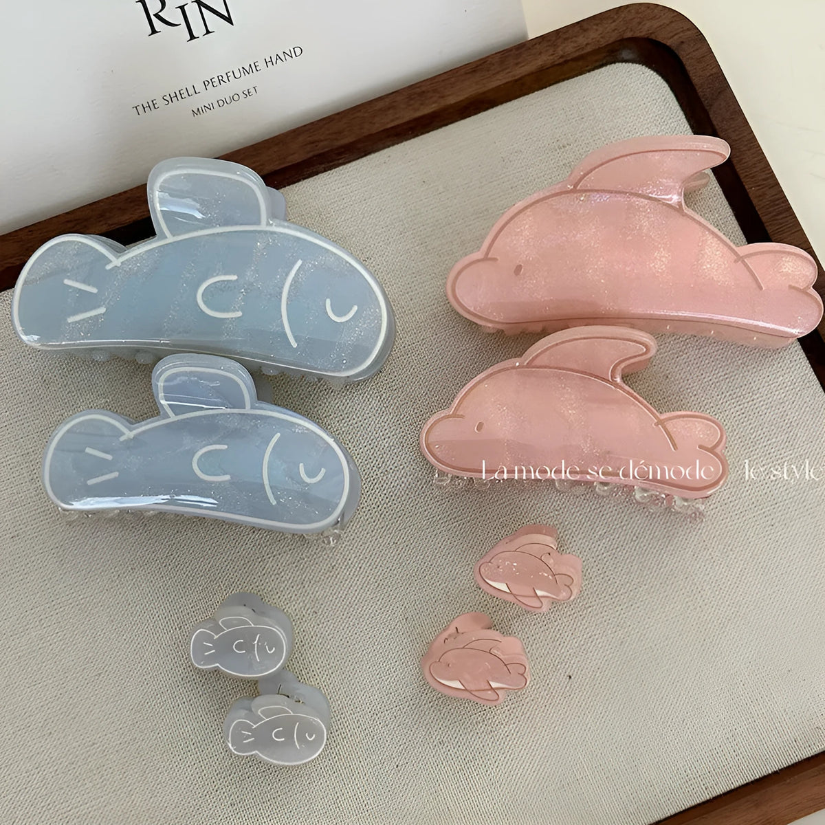 Dolphin grabber clip hair accessory for women in blue fish and pink dolphin colours, barrette style