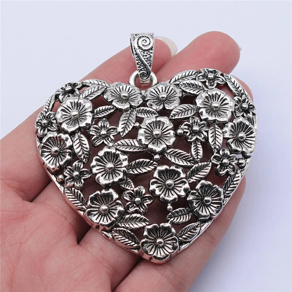 Ancient silver hollow flower alloy pendant measuring 67mm by 58mm