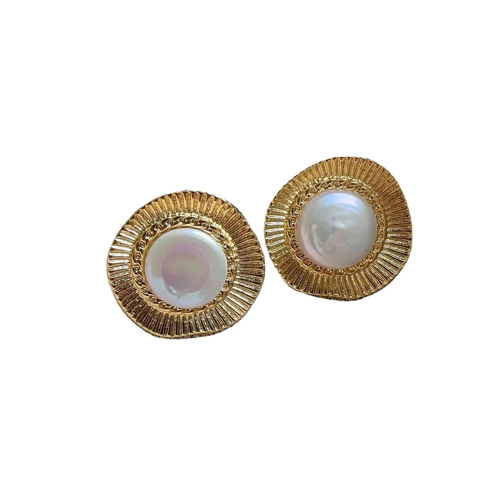 A pair of round gold-coloured retro style metal earrings for women.