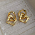 Retro geometric circle pendant earrings with a long drop, shown in gold and silver colour options.