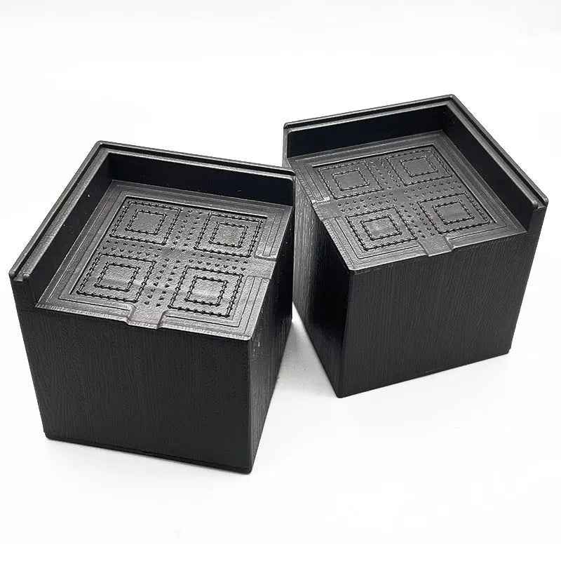 Four black plastic bed foot mats showing 2.5cm height increase for furniture legs