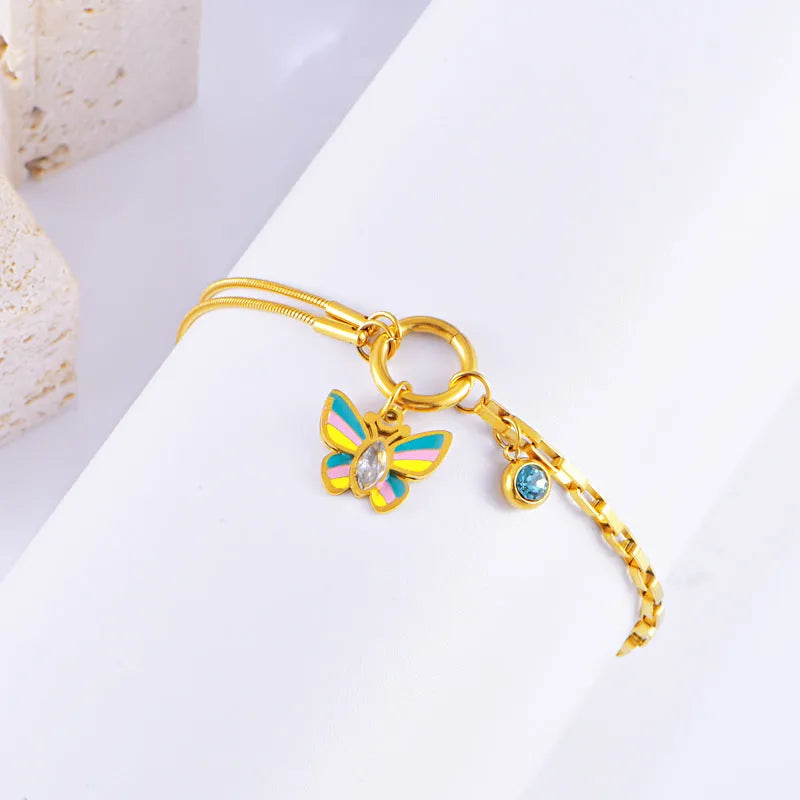 Gold titanium steel necklace and bracelet set with colourful epoxy butterfly and animal zodiac pendants.