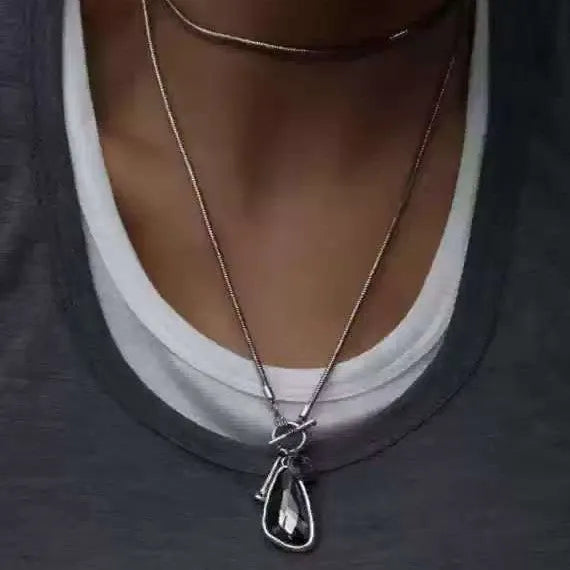 Long geometric alloy pendant necklace with snake bones chain for layering over jumpers