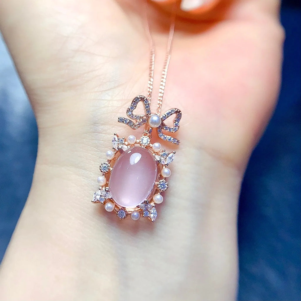 Geometric silver pendant with pink rose quartz crystal and rose gold plating on necklace chain