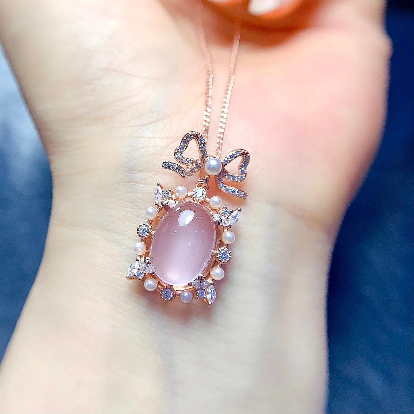 Geometric silver pendant with pink rose quartz crystal and rose gold plating on necklace chain