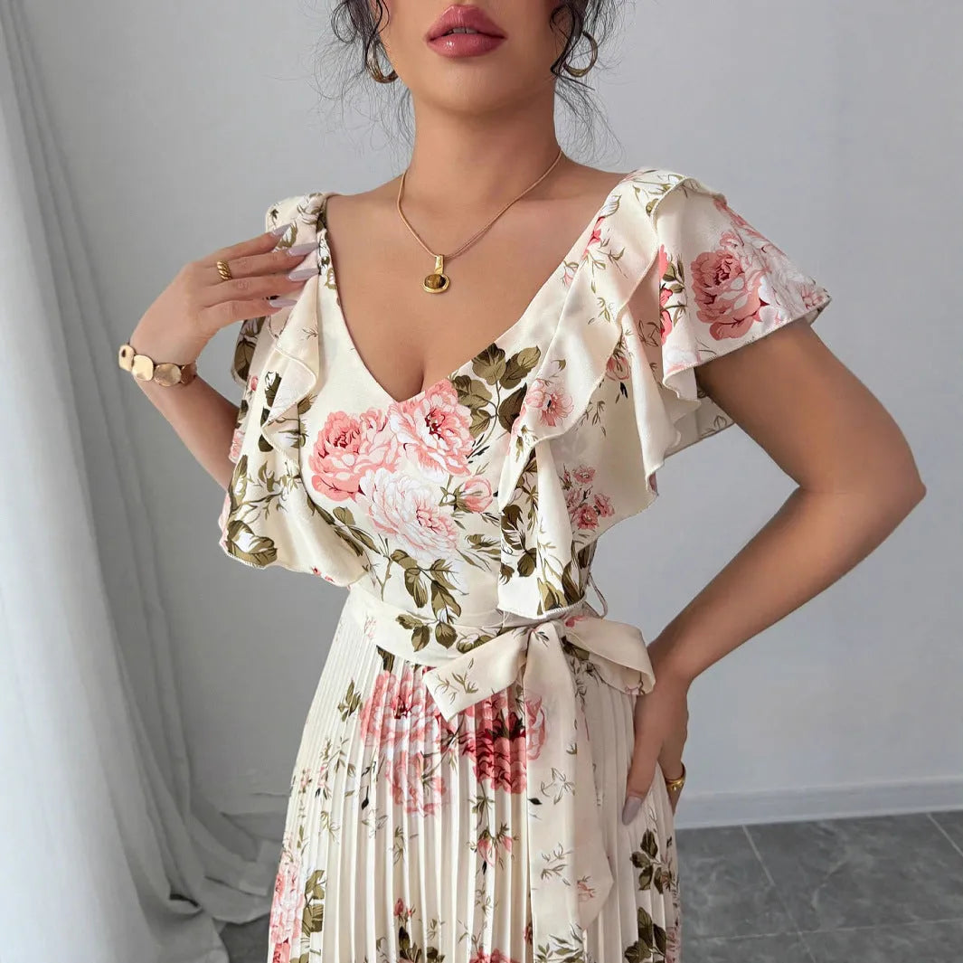 V-neck floral print dress with oversized swing skirt and ruffled sleeves in apricot colour, showing high waist and pleated details