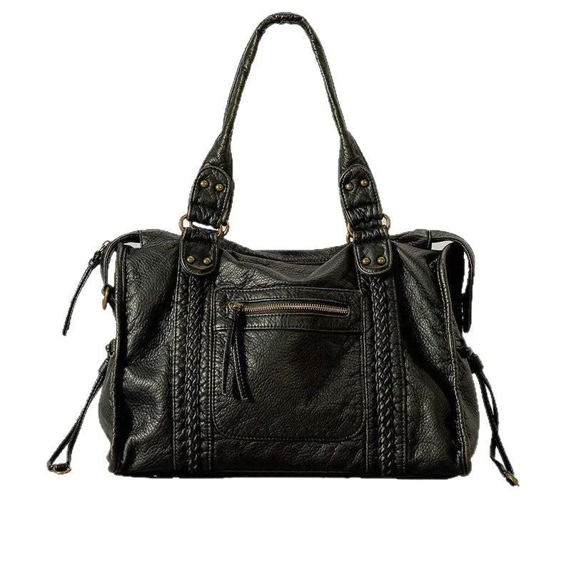 Women's retro messenger bag in bright black with golden edge, showing internal zipper compartments and weaving details