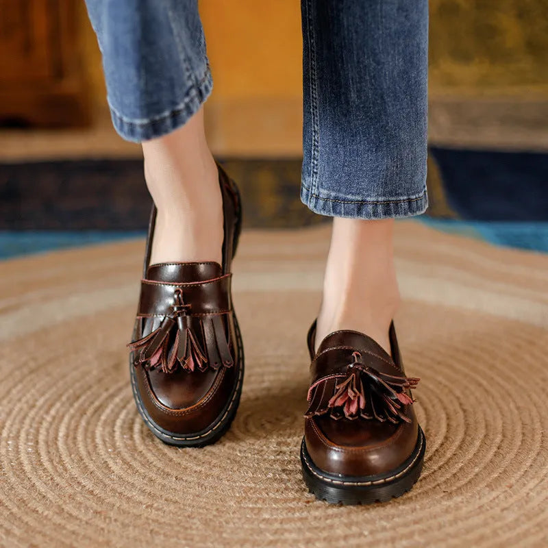 Women's brown leather tassel loafers with a chunky low heel and round toe