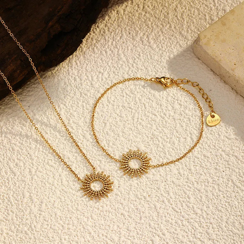 SUNFLOWER Series gold bracelet and necklace set with geometric chain design on a white background