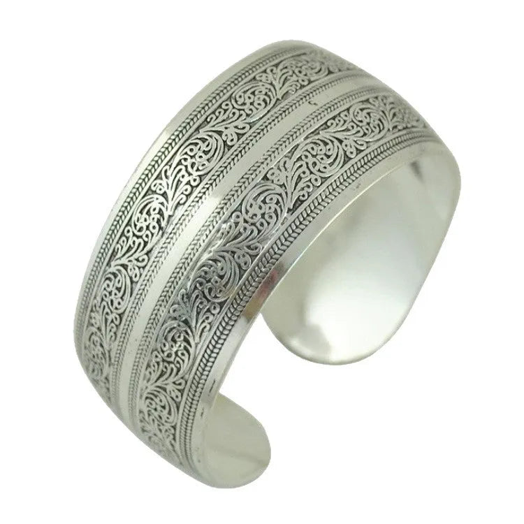 Ethnic style Miao silver bracelet with open carved design in Roman shape, showing diamond treatment surface detail