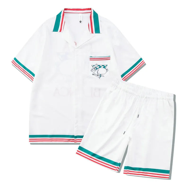 Plaid patterned short-sleeve shirt and matching trousers laid flat, a blue and white beachwear set.