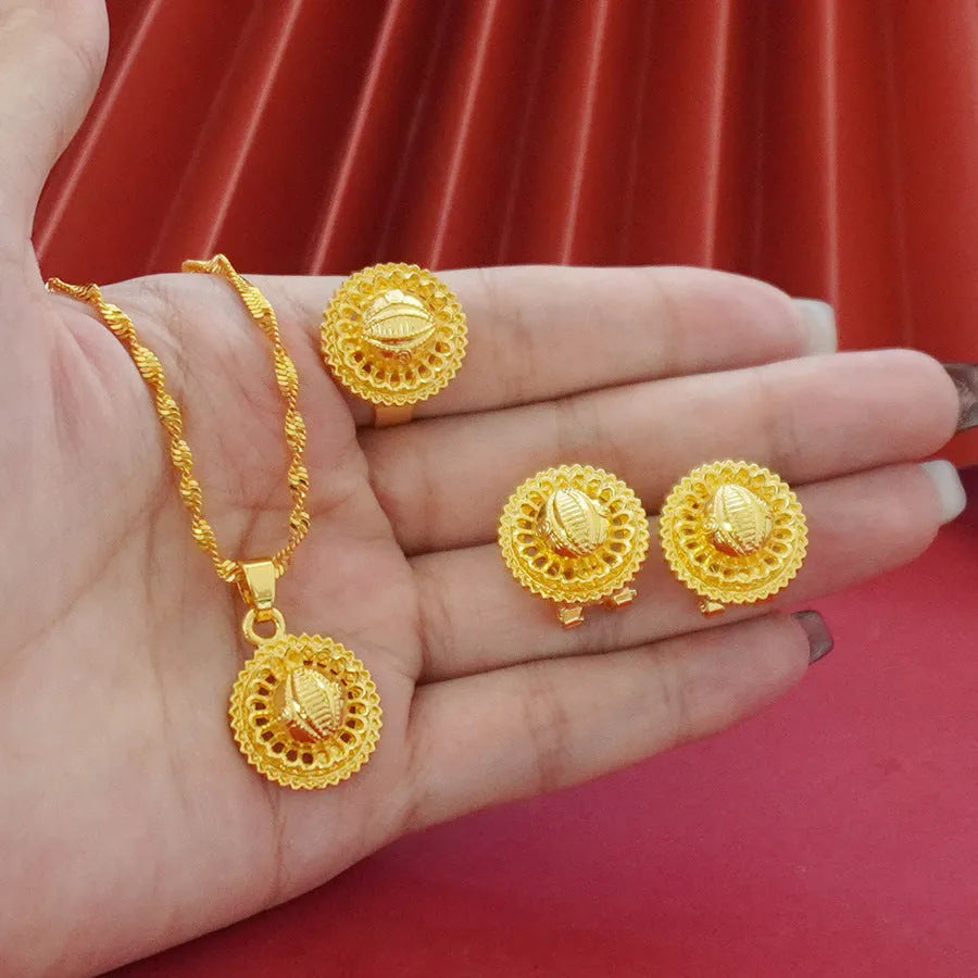 Gold-plated three-piece jewellery set with floral design, showing necklace, earrings, and ring with electroplated finish