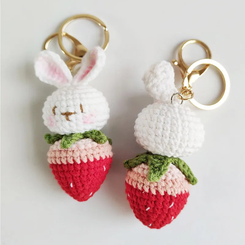 White hand-woven rabbit strawberry pendant with cartoon design and attached key on four-strand doll wire