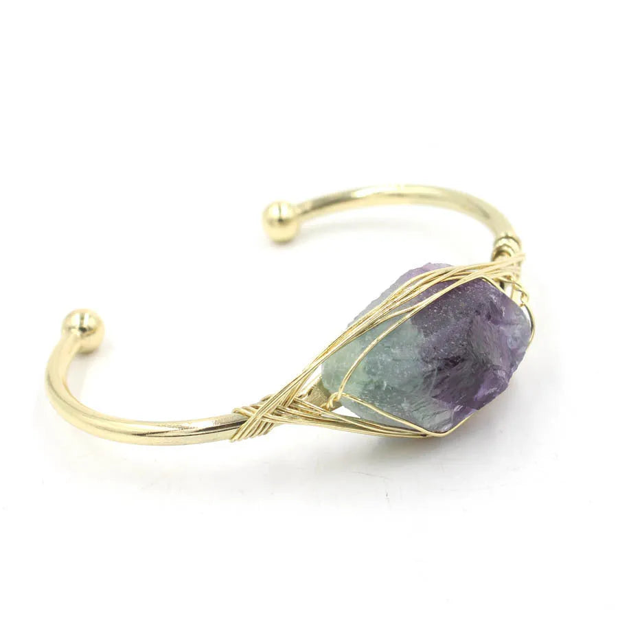 Natural raw gemstone bracelet with 8mm amorphous crystals in various colours on a wrist, showing ethnic style and simple clasp.